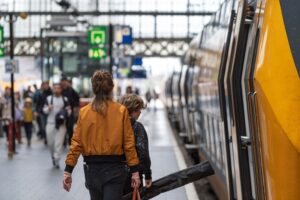 Traveller boarding a UK train platform, representing savings with a Railcard