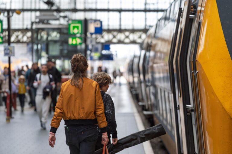 Traveller boarding a UK train platform, representing savings with a Railcard