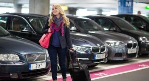Driver handing over car keys for Purple Parking meet and greet service at a UK airport terminal