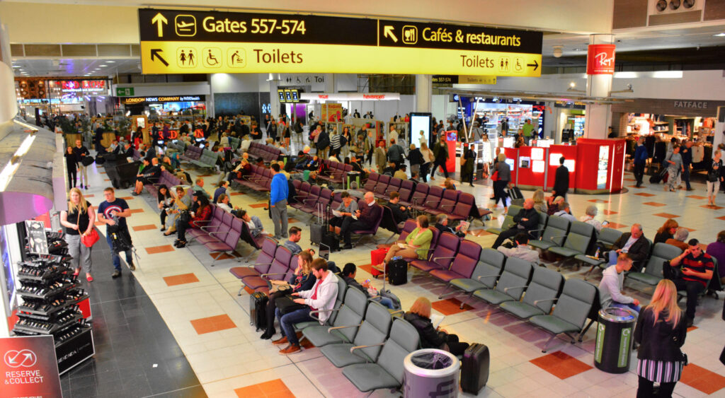 A Jersey Family Lost £5,000 Because an Airline Did Not Recognise Their Passport. Here Is How to Avoid It | Departures concourse inside Gatwick Airport North Terminal with passengers and shops