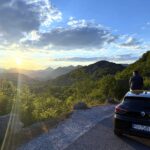 Driving in Montenegro: sunset over the Lake Skadar mountains from a roadside viewpoint
