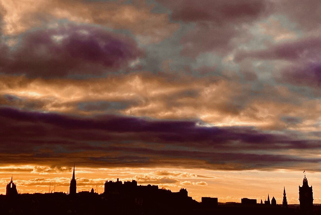 Edinburgh Old Town skyline silhouetted at sunset with the castle and spires