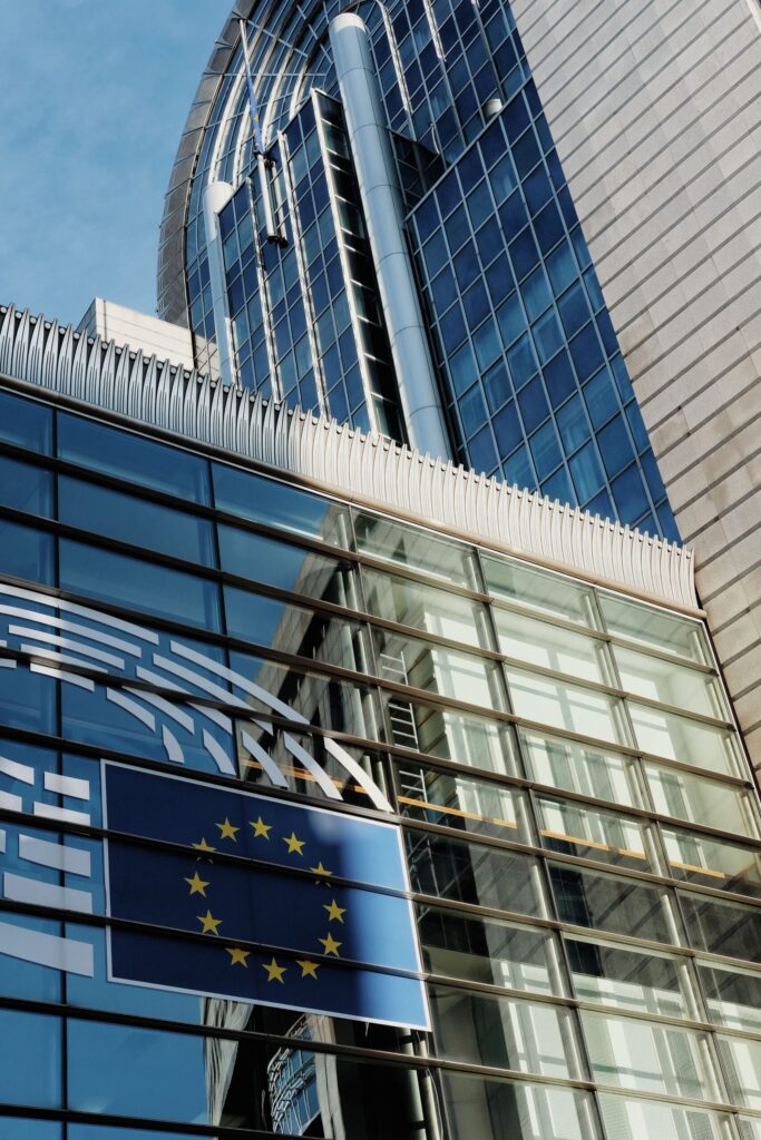 EU Parliament Brussels building exterior with European Union flag close-up