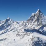 Genius Travels - Advenutre Travel Guides | Matterhorn and Pennine Alps peaks covered in snow with clear blue sky