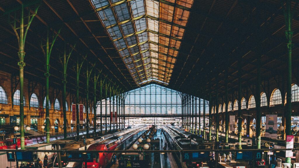 Paris Gare du Nord station interior with vaulted iron roof and trains at platforms viewed from above