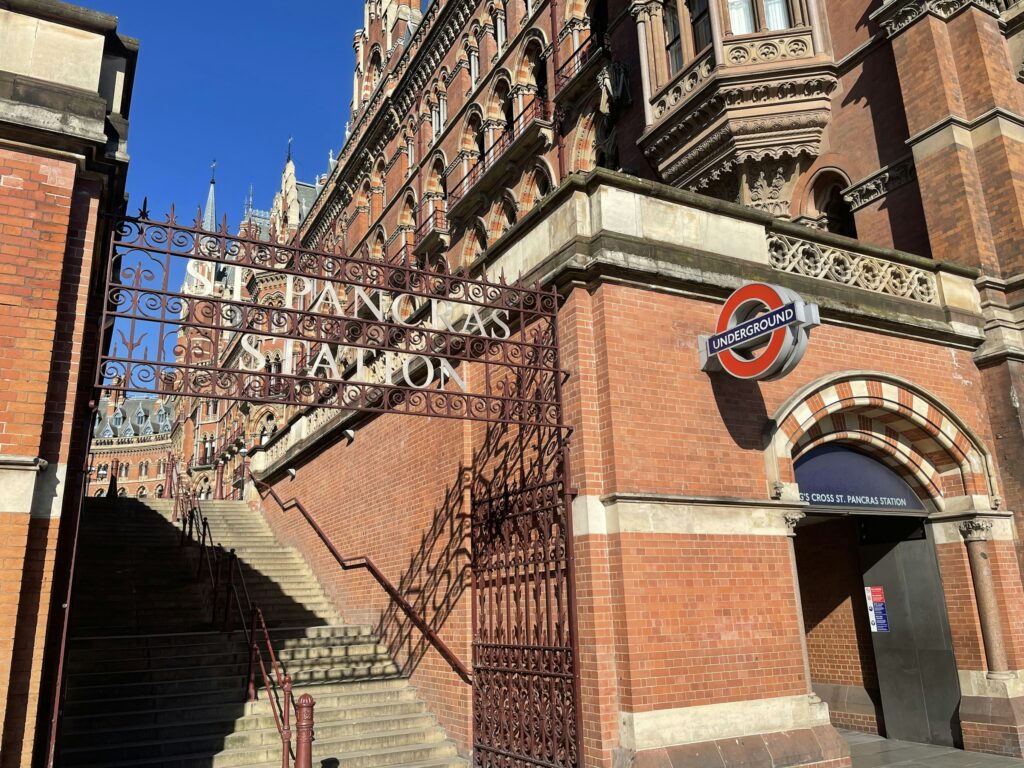 St Pancras Station entrance gate with London Underground roundel and red brick facade