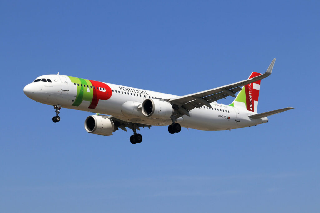 TAP Air Portugal A321neo aircraft in flight with green red livery and flytap.com markings