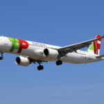 TAP Air Portugal A321neo aircraft in flight with green red livery and flytap.com markings