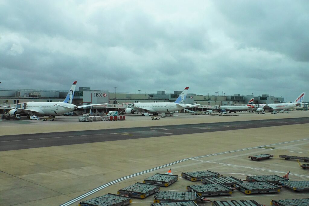 Aircraft parked on stand at Gatwick South Terminal under grey cloud
