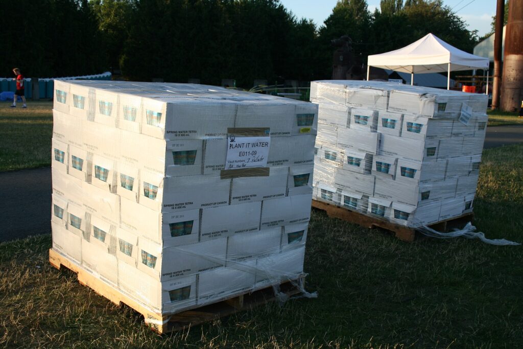 Pallets of bottled water stacked and shrink wrapped ready for distribution