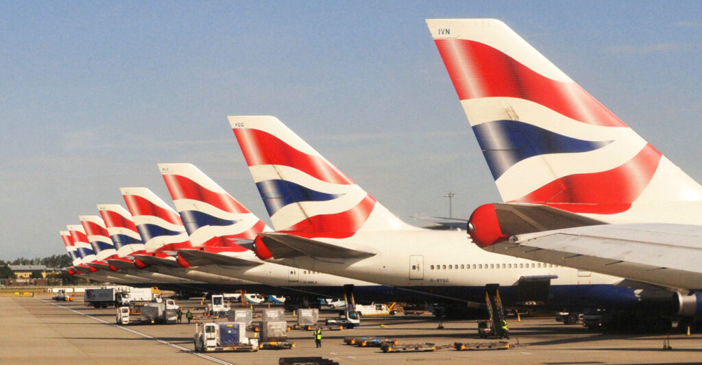 Row of British Airways tailfins parked on the apron at London Heathrow