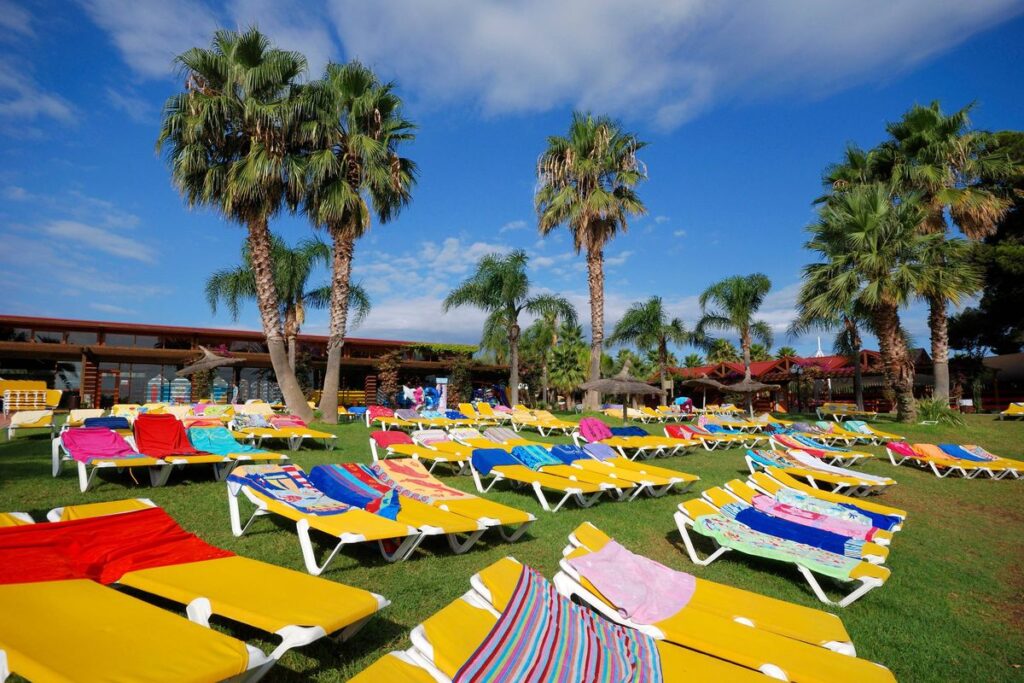 Sunbed Wars Escalate: Tenerife Towel-Tossing Goes Viral as German Court Sides With Holidaymakers | Rows of empty sun loungers covered in towels beside a hotel swimming pool