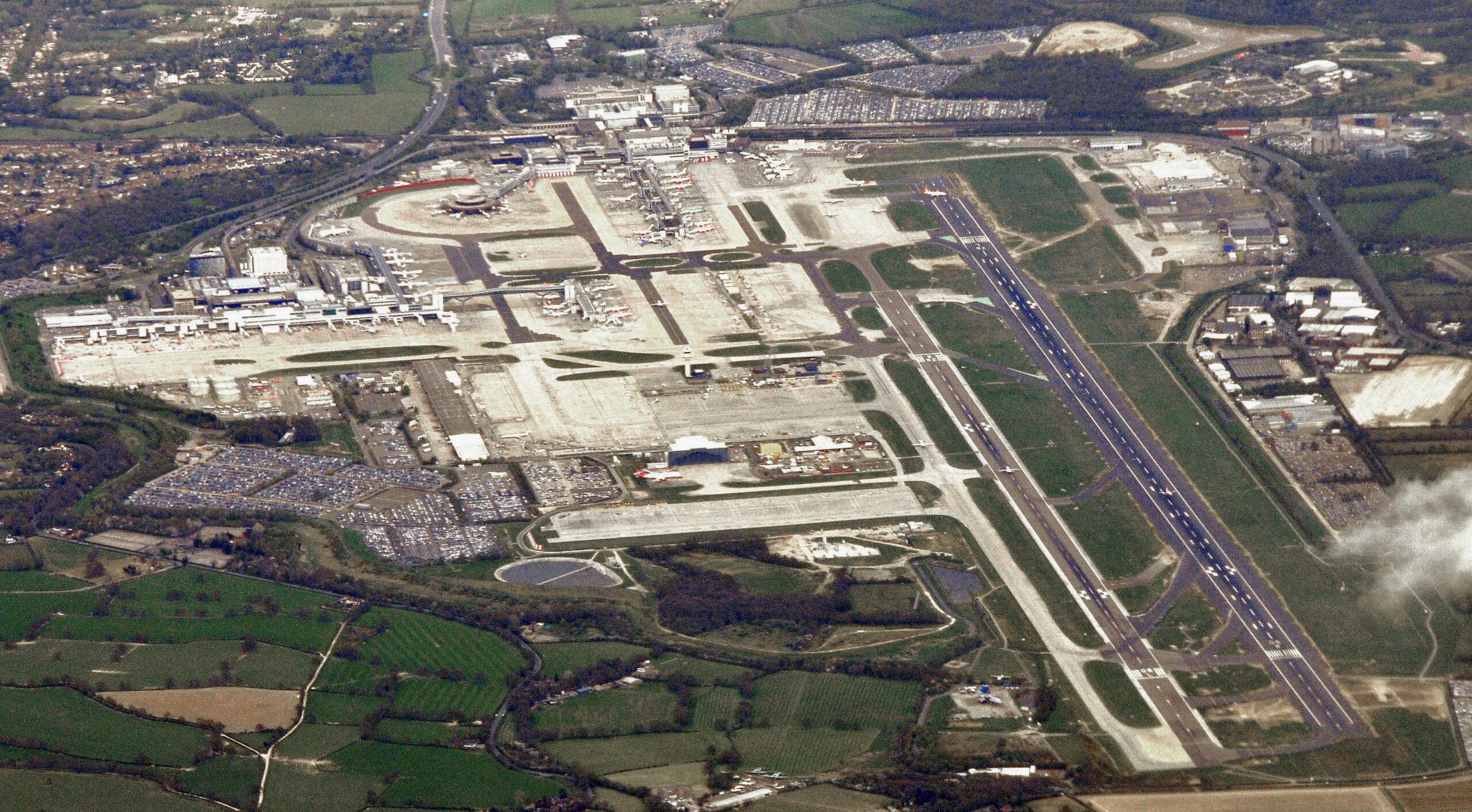 Aerial view of London Gatwick Airport showing terminals runway and countryside for the gatwick second runway story