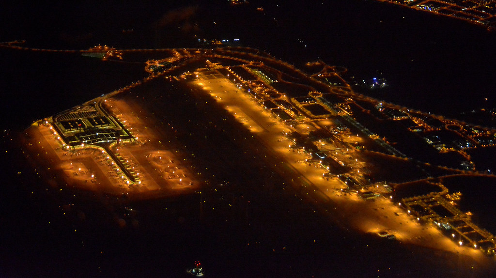 Barcelona El Prat airport lit up at night seen from the air