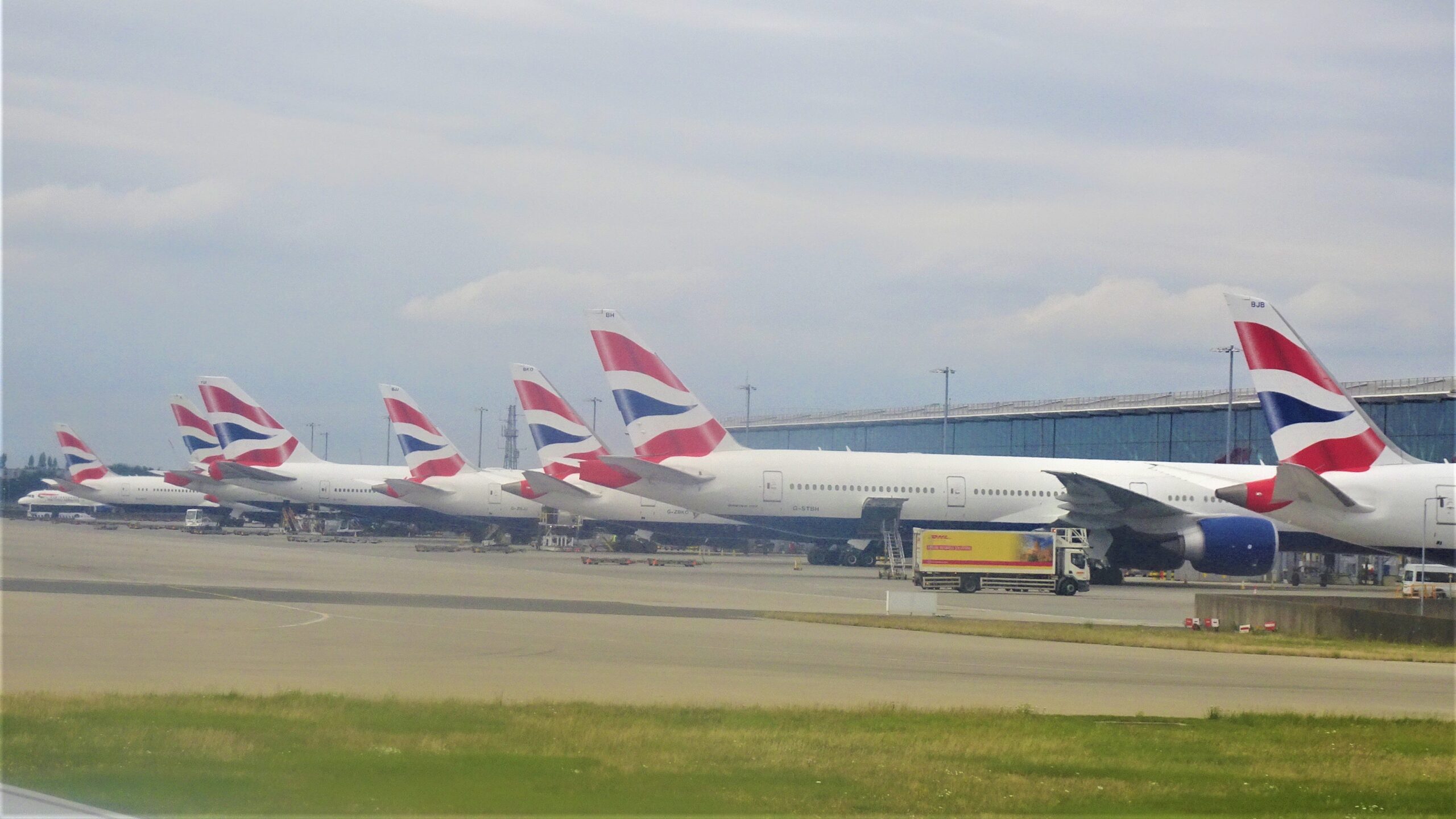 British Airways tailfins lined up on stand at London Heathrow Terminal 5