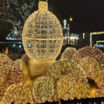 Giant illuminated golden baubles at the Vienna Christkindlmarkt at night