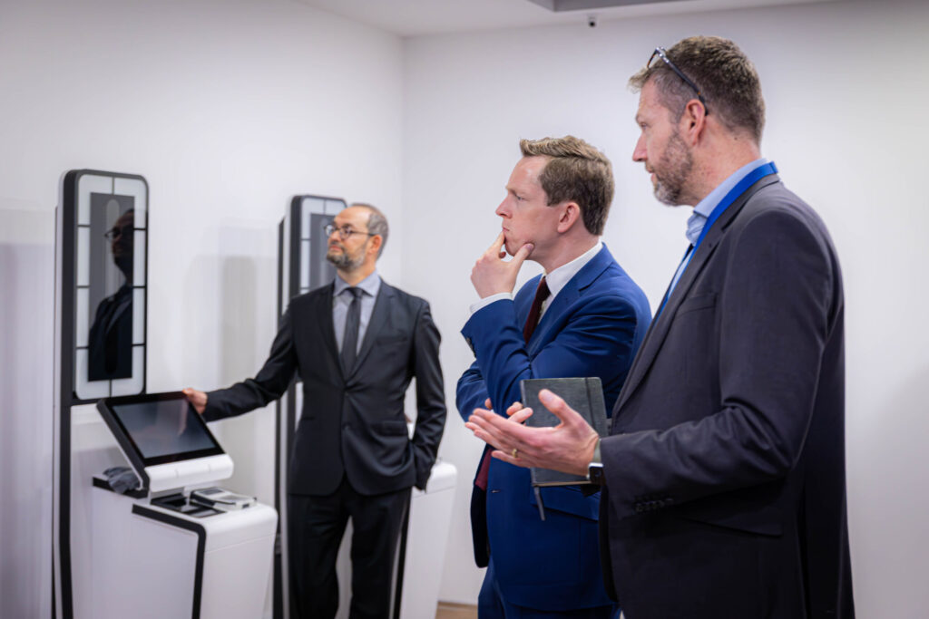 Officials viewing EES self-service registration kiosks at St Pancras International in London
