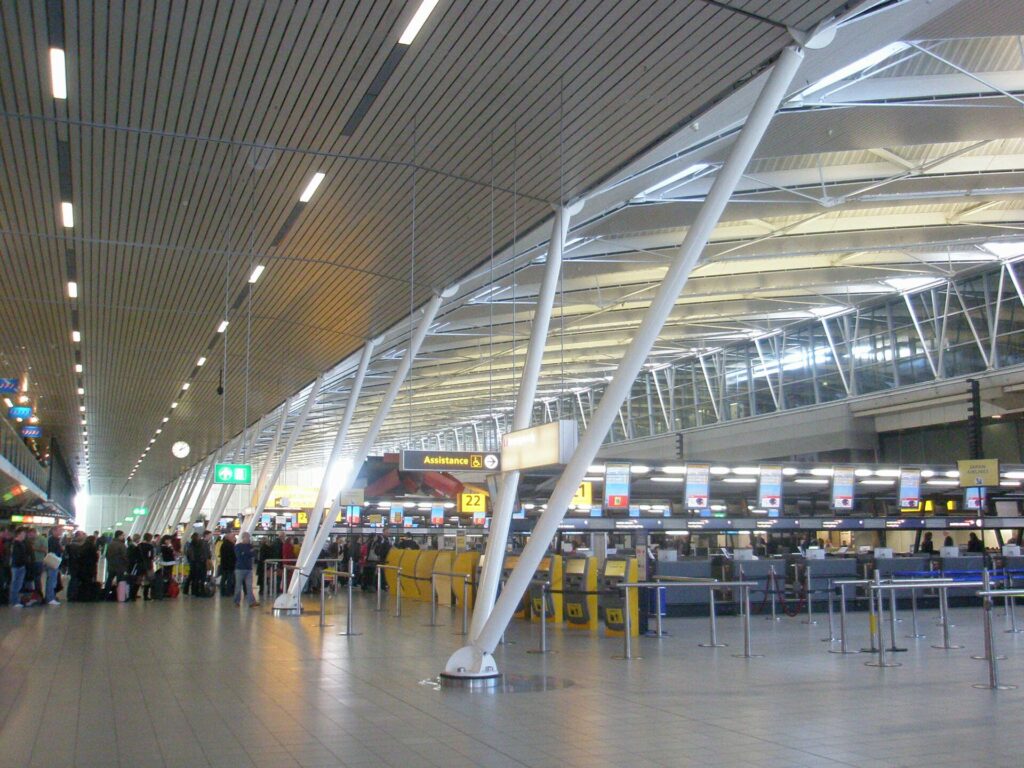 Passengers in the departures hall at Amsterdam Schiphol Airport