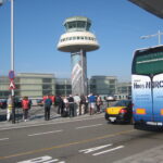 Genius Travels - Advenutre Travel Guides | Passengers moving through the airy departures concourse at Barcelona El Prat Terminal 1