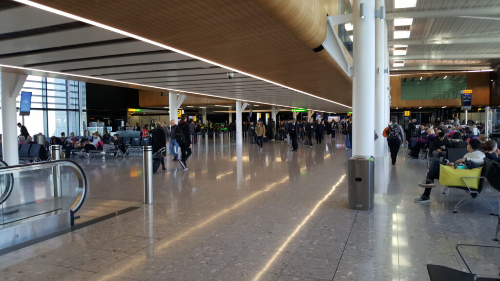 Passengers walking through the Terminal 2 concourse at Heathrow Airport