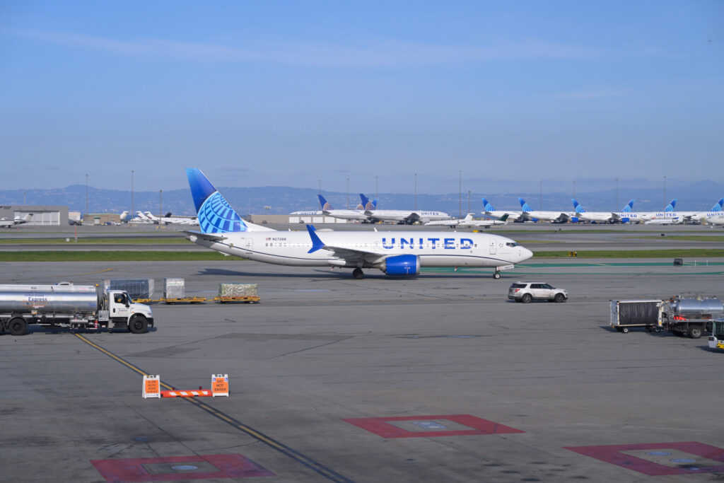 United Boeing 737-8 MAX taxiing on the apron at San Francisco with other jets behind