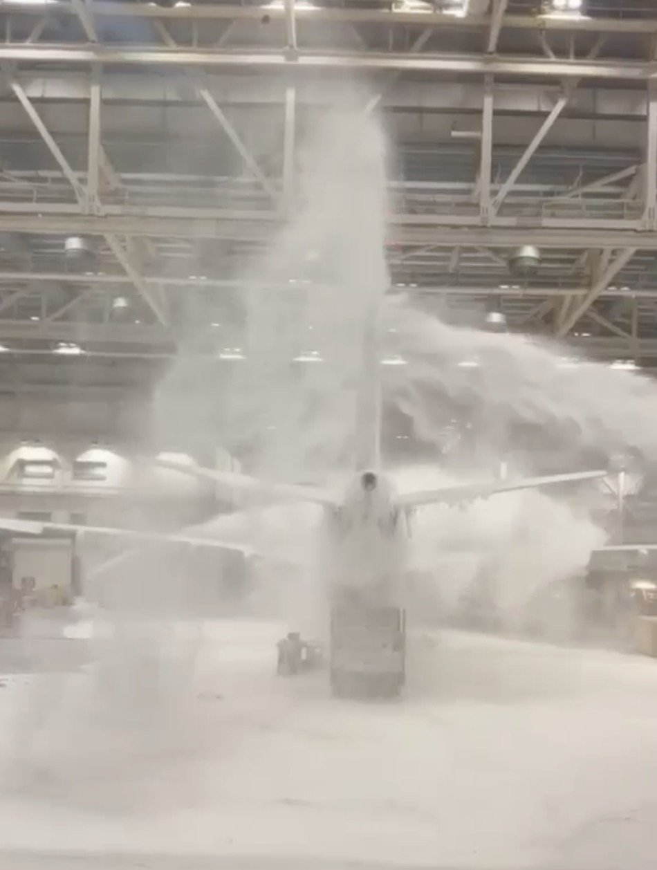 Virgin Atlantic foam at Heathrow: jet buried under foam inside a hangar at night