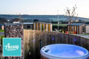 Away Resorts logo with UK holiday park caravans in the background