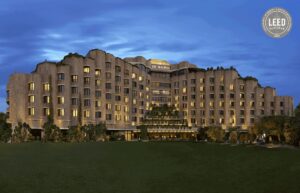 ITC Hotels logo with a luxury hotel exterior