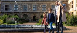 Visitors exploring an English Heritage castle on a sunny day