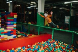 Family enjoying a day out at a theme park with Kids Pass discounts