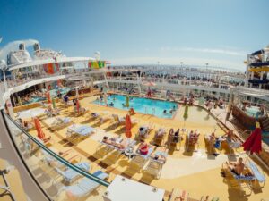 MSC Cruises ship sailing at sunset with passengers on deck