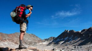 Hiker wearing an Osprey backpack on a mountain trail