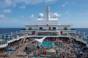Cruise ship sailing at sunset, Cruise Nation holiday banner