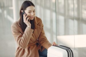 Traveller using the Jetpac app on a phone at an airport, for Jetpac discount codes