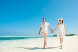 Couple relaxing by a pool at an all-inclusive resort booked through Travel Republic