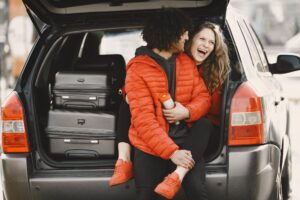 Traveller wheeling a suitcase towards an airport Meet and Greet parking drop-off