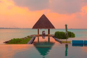 Overwater villa and turquoise lagoon at a SAii Resorts island property