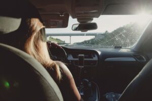 Rexing dash cam mounted on a car windscreen with the road ahead
