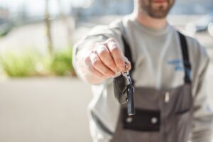 Driver handing car keys to an Ace Airport Parking meet and greet valet at a UK airport terminal